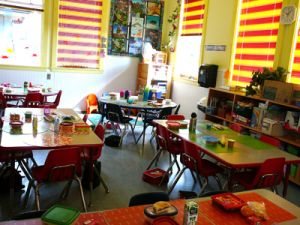 Bright classroom with small tables and chairs