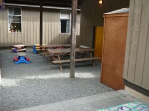 Covered outdoor play area with picnic tables